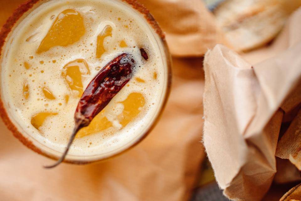 A fruity beverage with a dried chili pepper