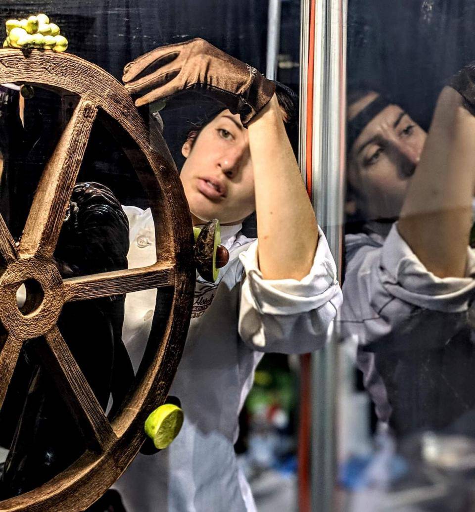 Juidth LaMontagne works on a chocolate sculpture