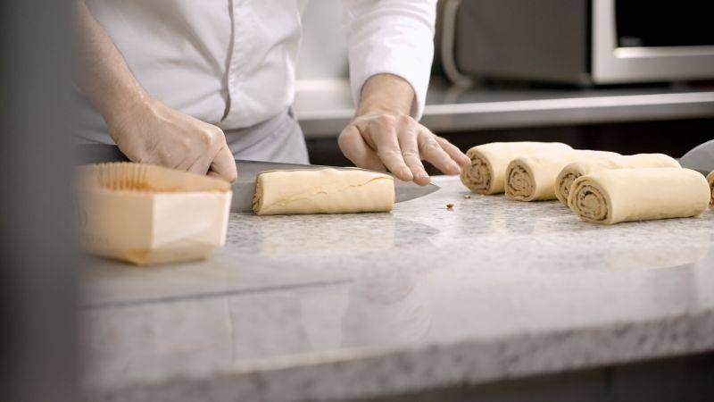 chef romain rolling dough on counter