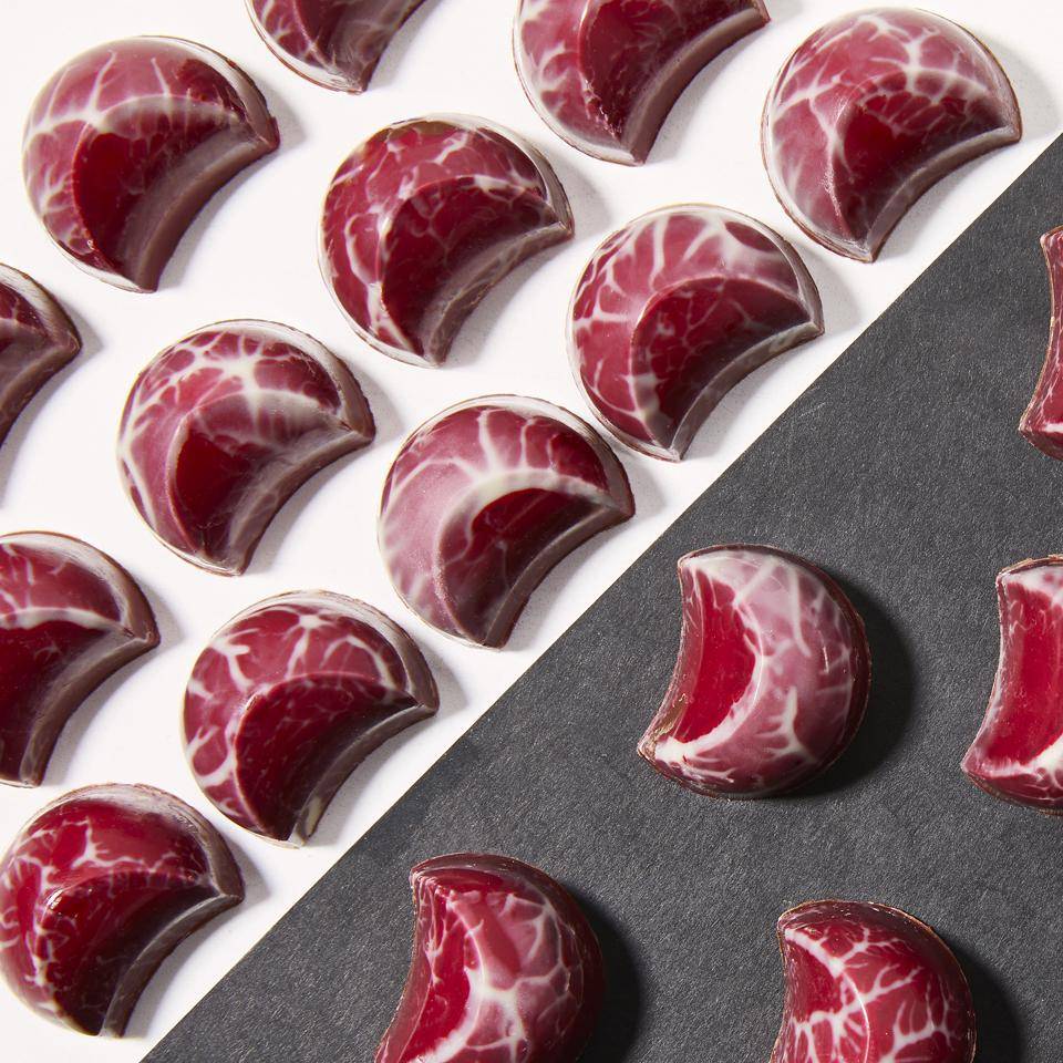 Ruby chocolates on a white and black background