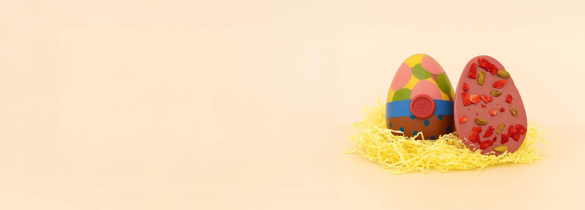 Two colorful easter eggs on a green background