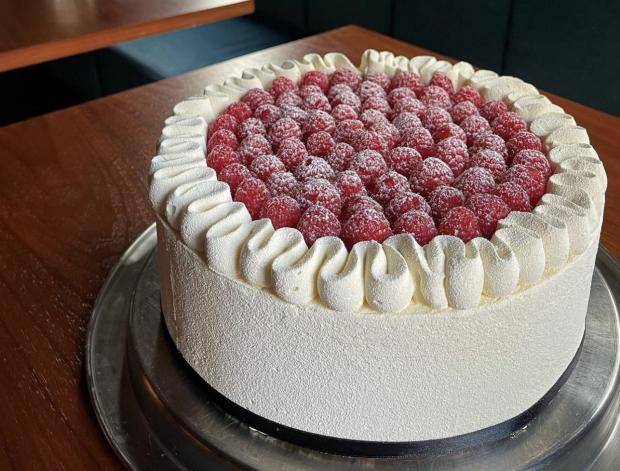 white ruffle cake with raspberries