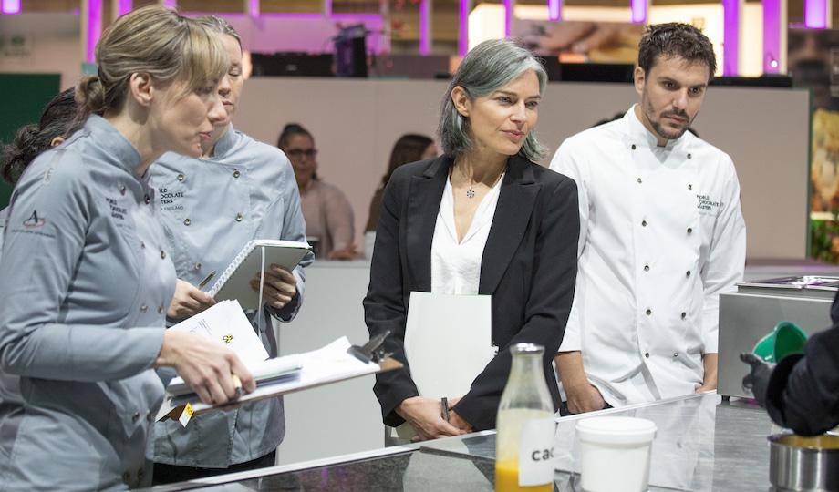 Chocolate Academy™ chefs and jury members observing a competitor's work