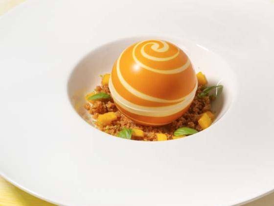 A dessert featuring a Mona Lisa 3D printed chocolate sphere